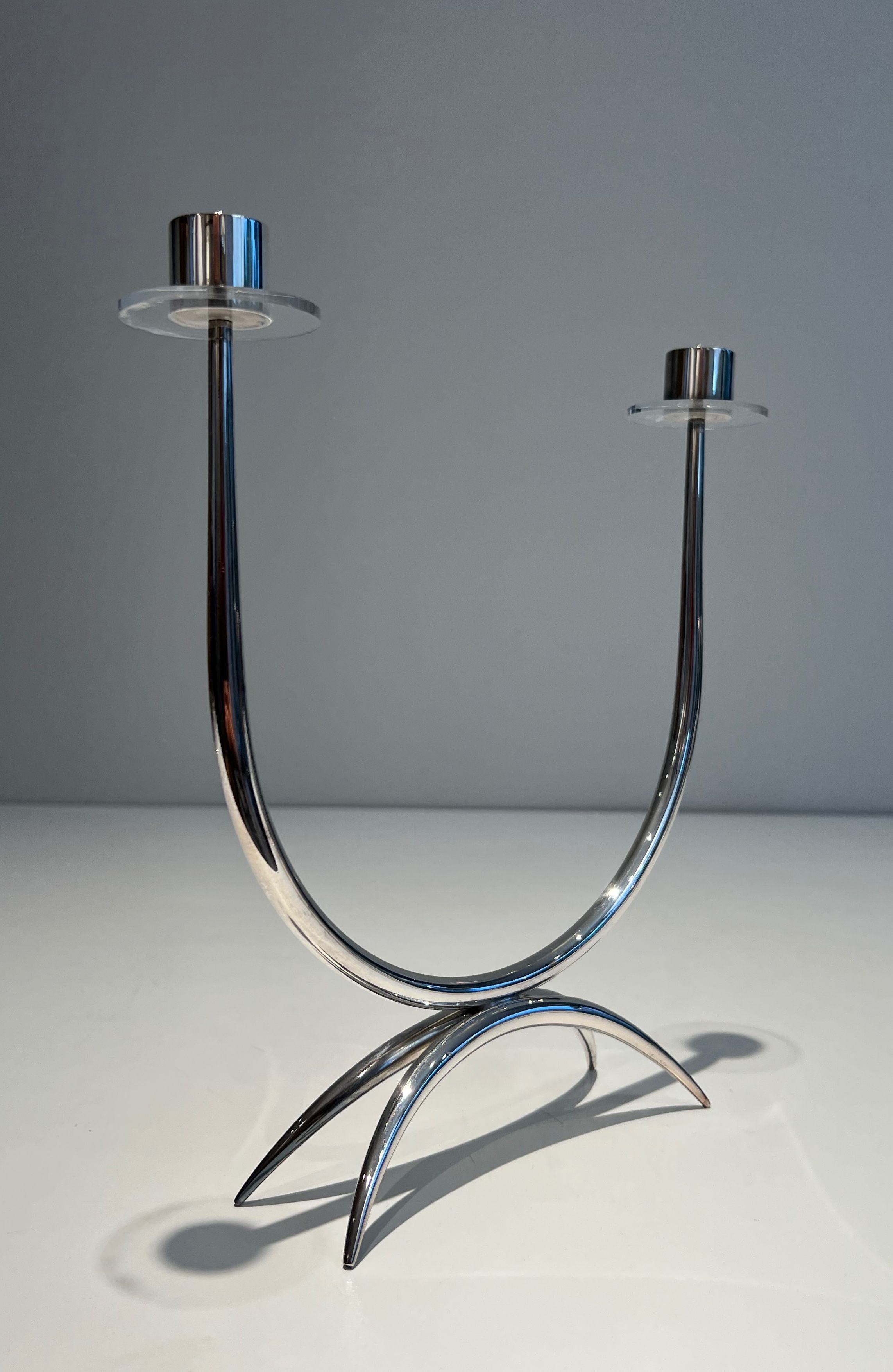 Silver-plated metal and plexiglass design candlestick.