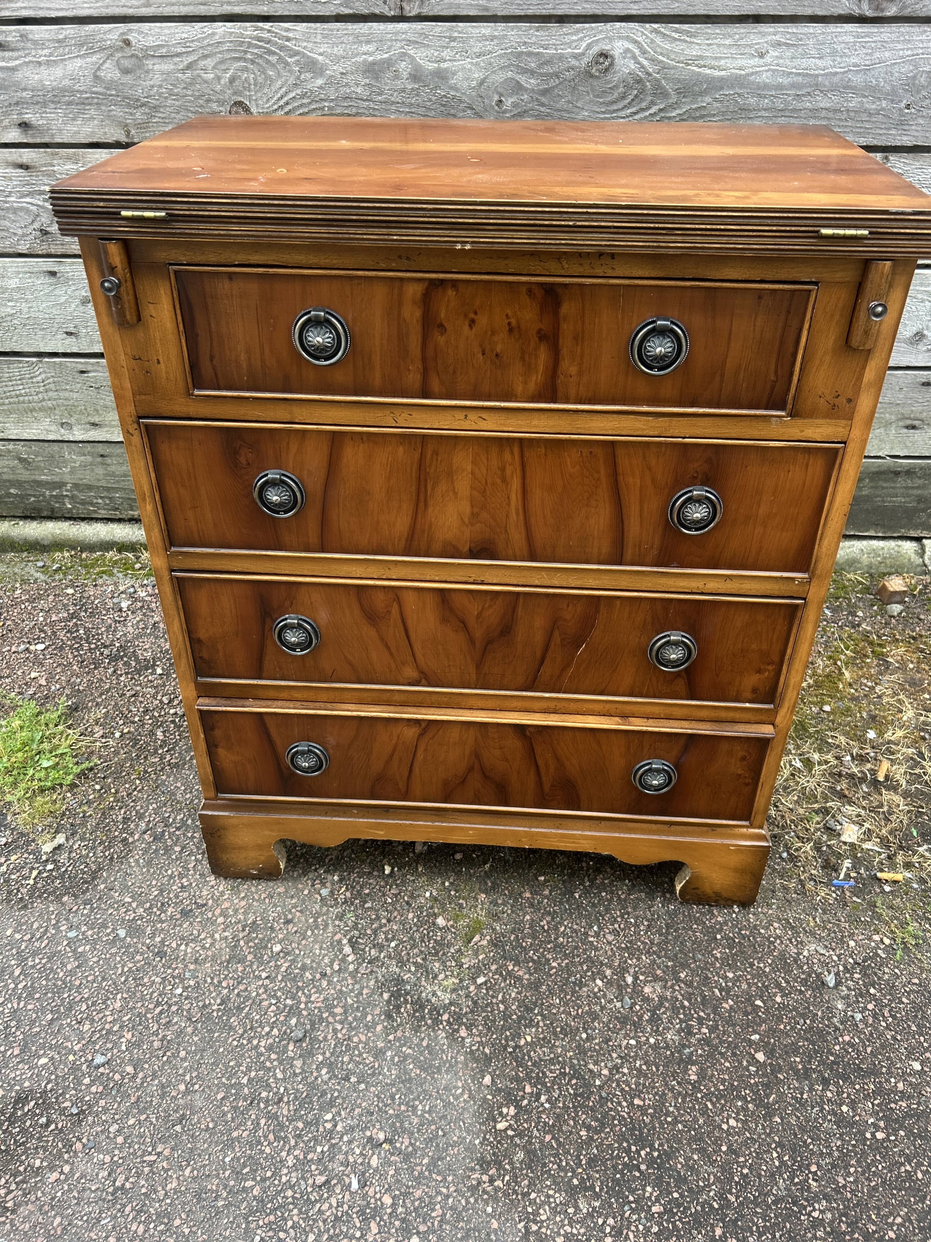 Small English chest of drawers with a folding top.