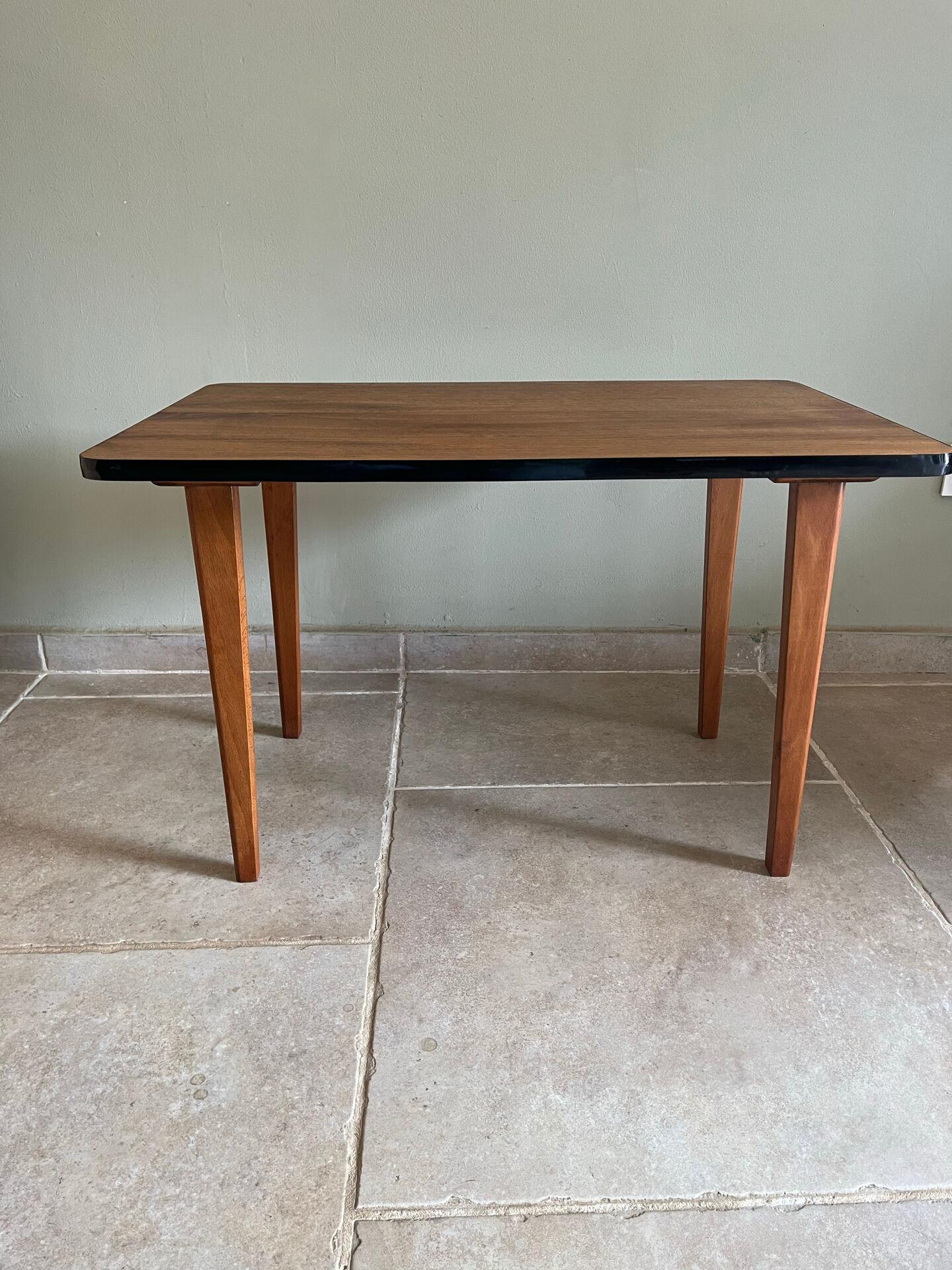 Mid-century coffee table with tapered legs.