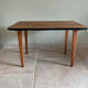 Mid-century coffee table with tapered legs.