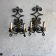 Pair of wall sconces in wrought iron with golden leaf patterns.