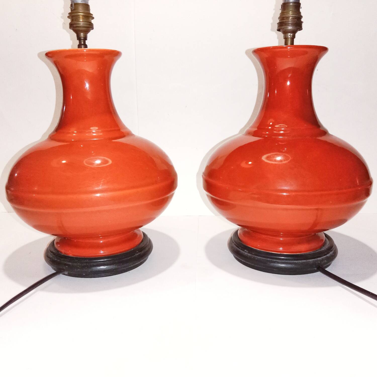 Pair of ceramic lamp bases in the shape of orange gourds.