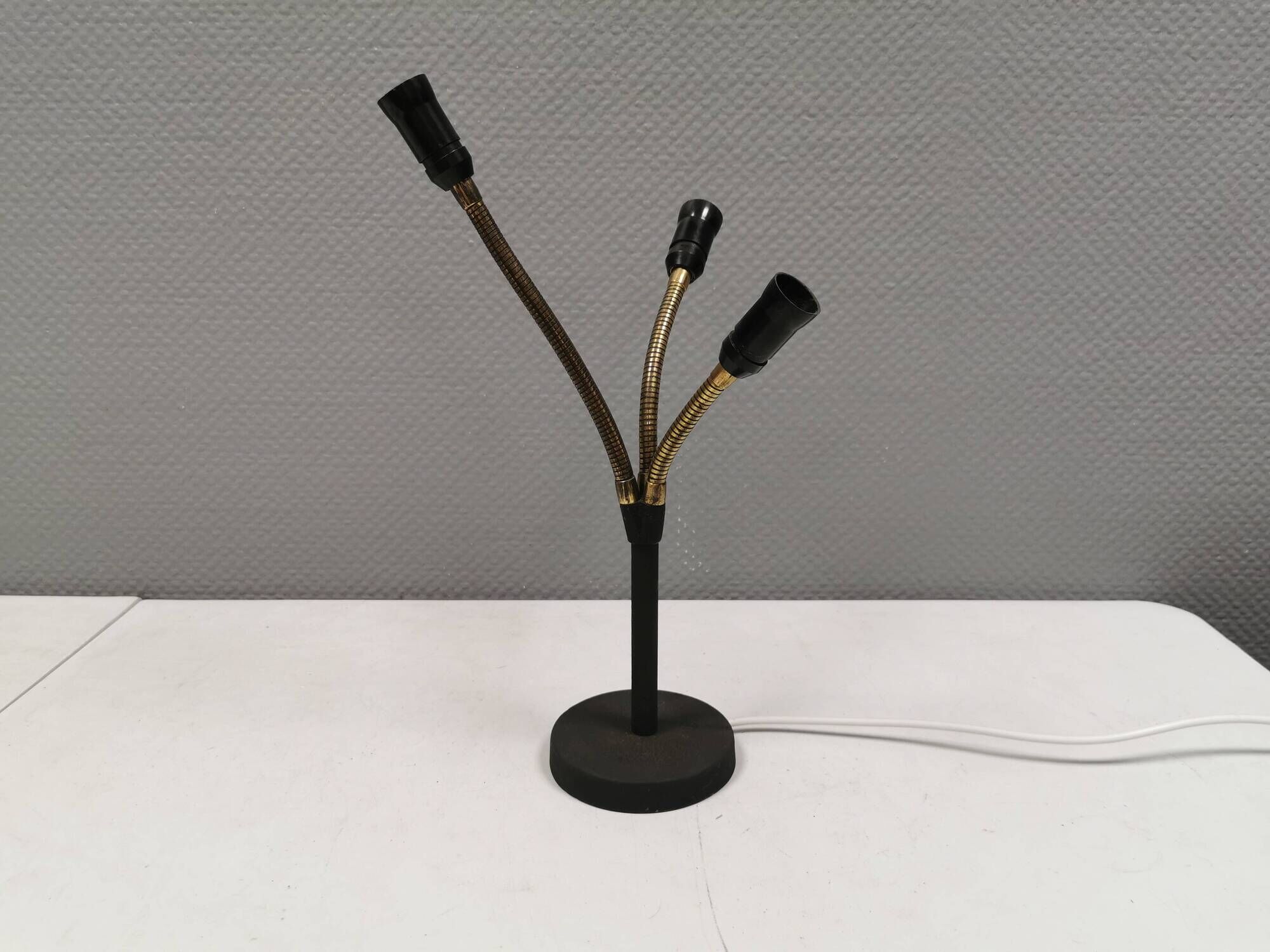 Old cast iron table lamp with brass bend and 3 light sources