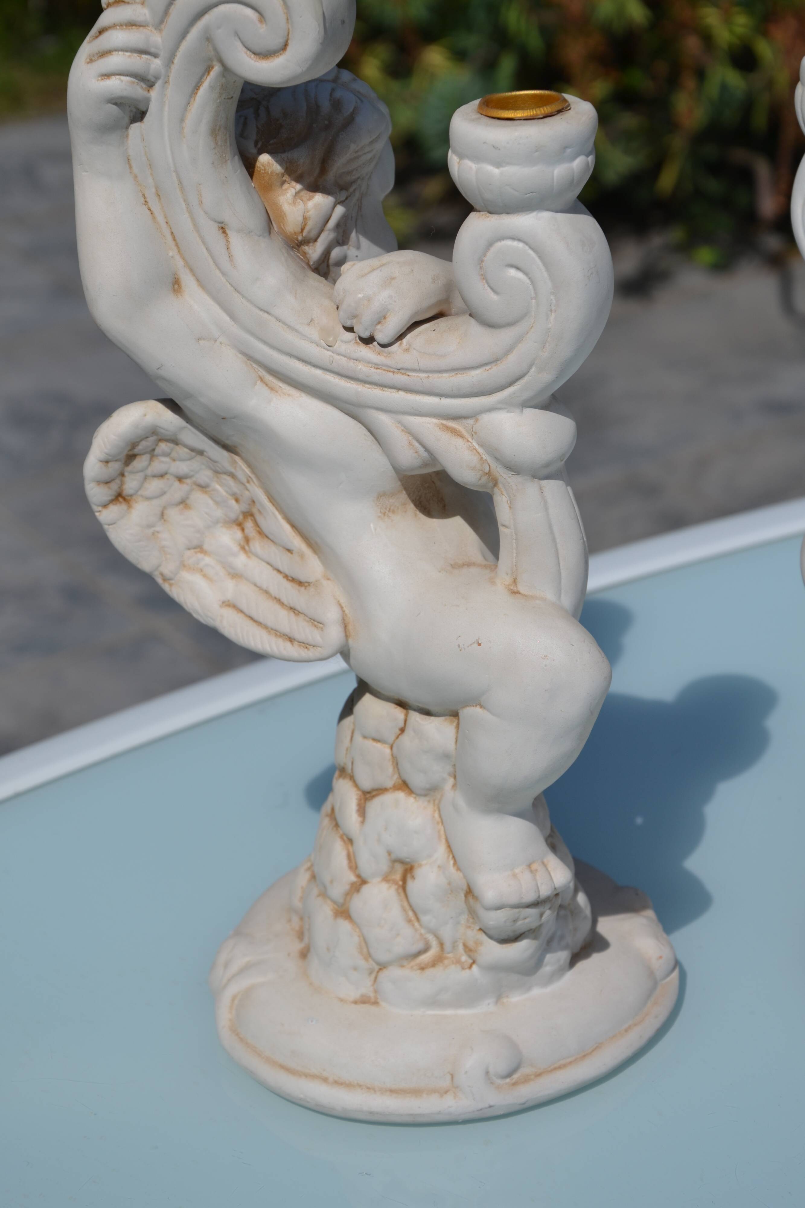 Pair of "cherub" candle holders in plaster