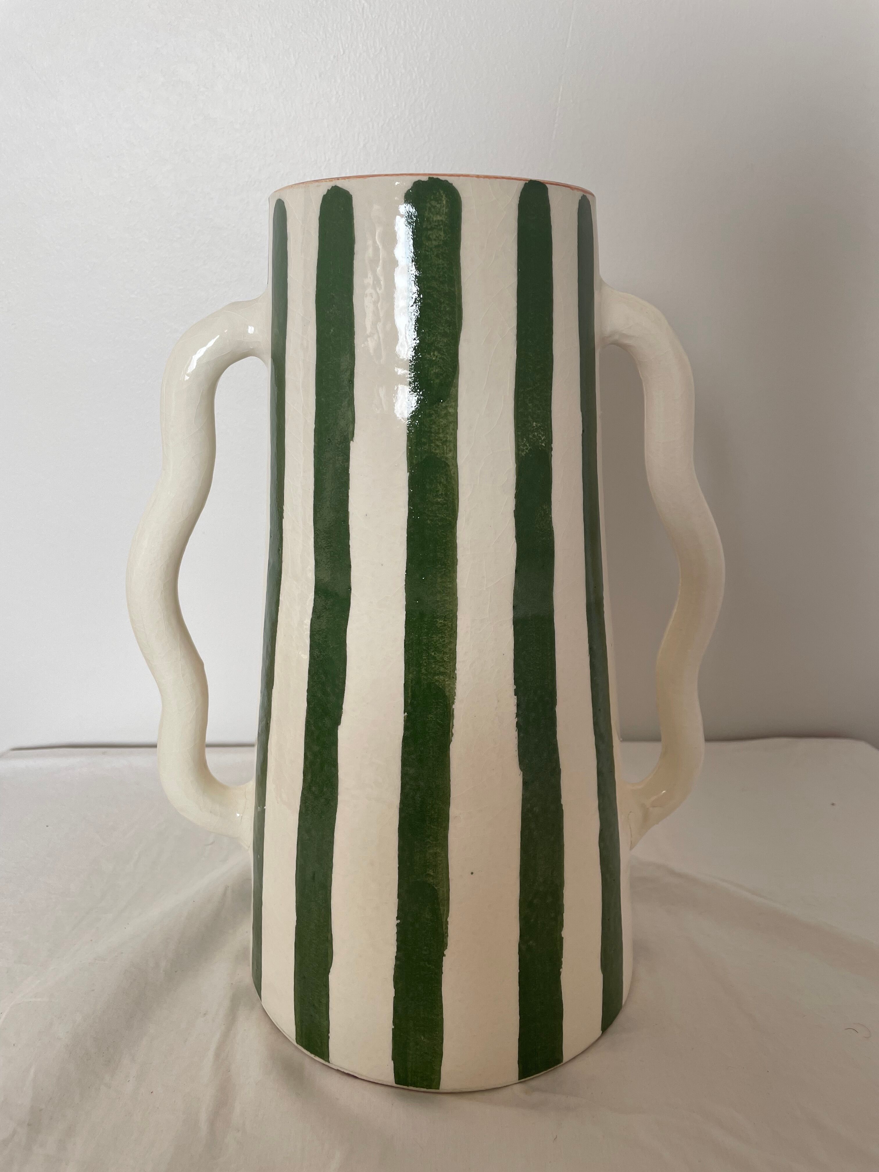 Handmade green and white striped ceramic vase with abstract corrugated handheld