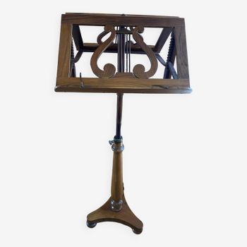 Double walnut music stand with lyre decoration.