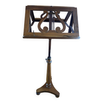 Double walnut music stand with lyre decoration.