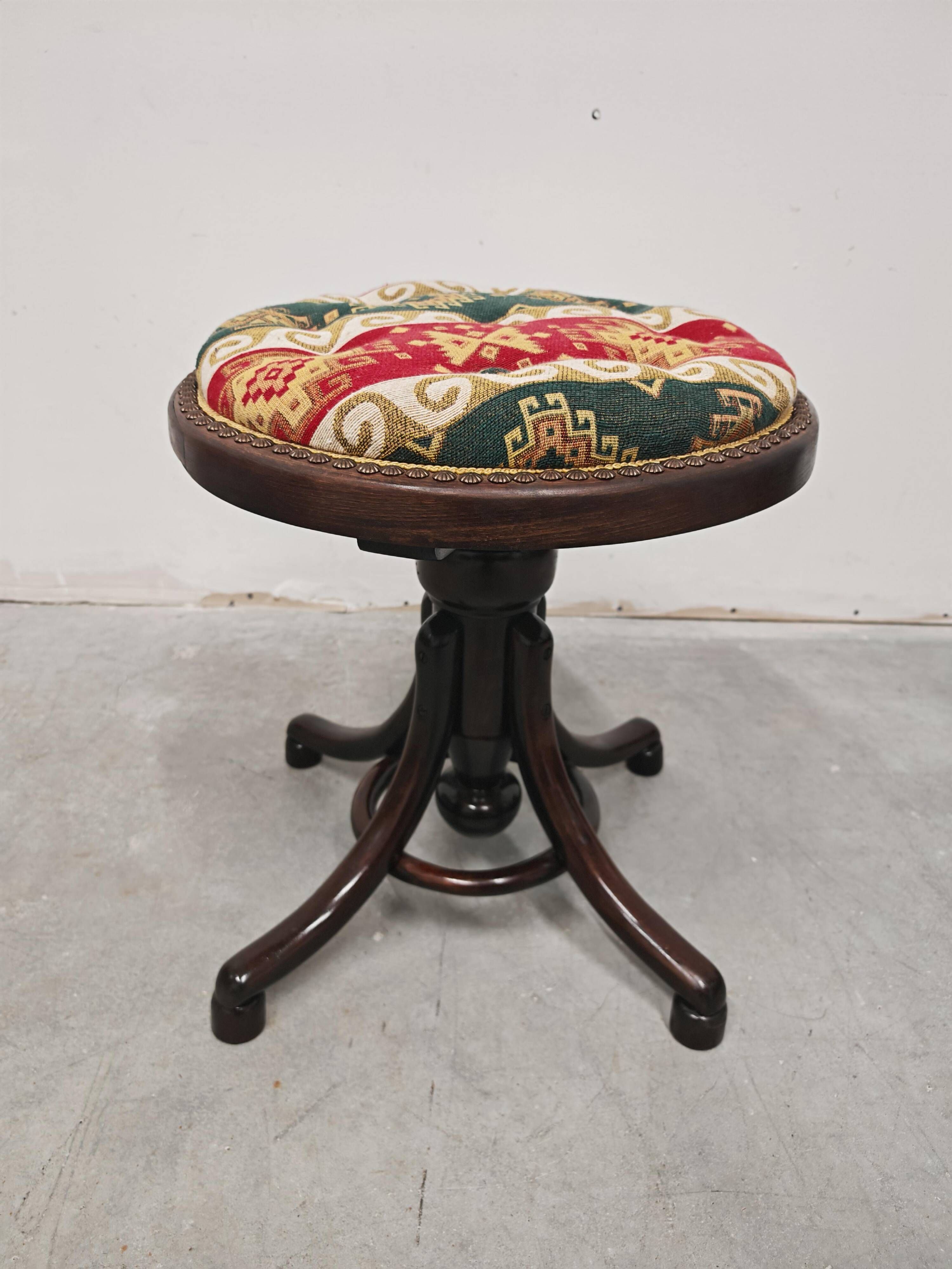 Antique curved wooden piano stool with kilim fabric from the 1910s.