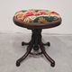 Antique curved wooden piano stool with kilim fabric from the 1910s.