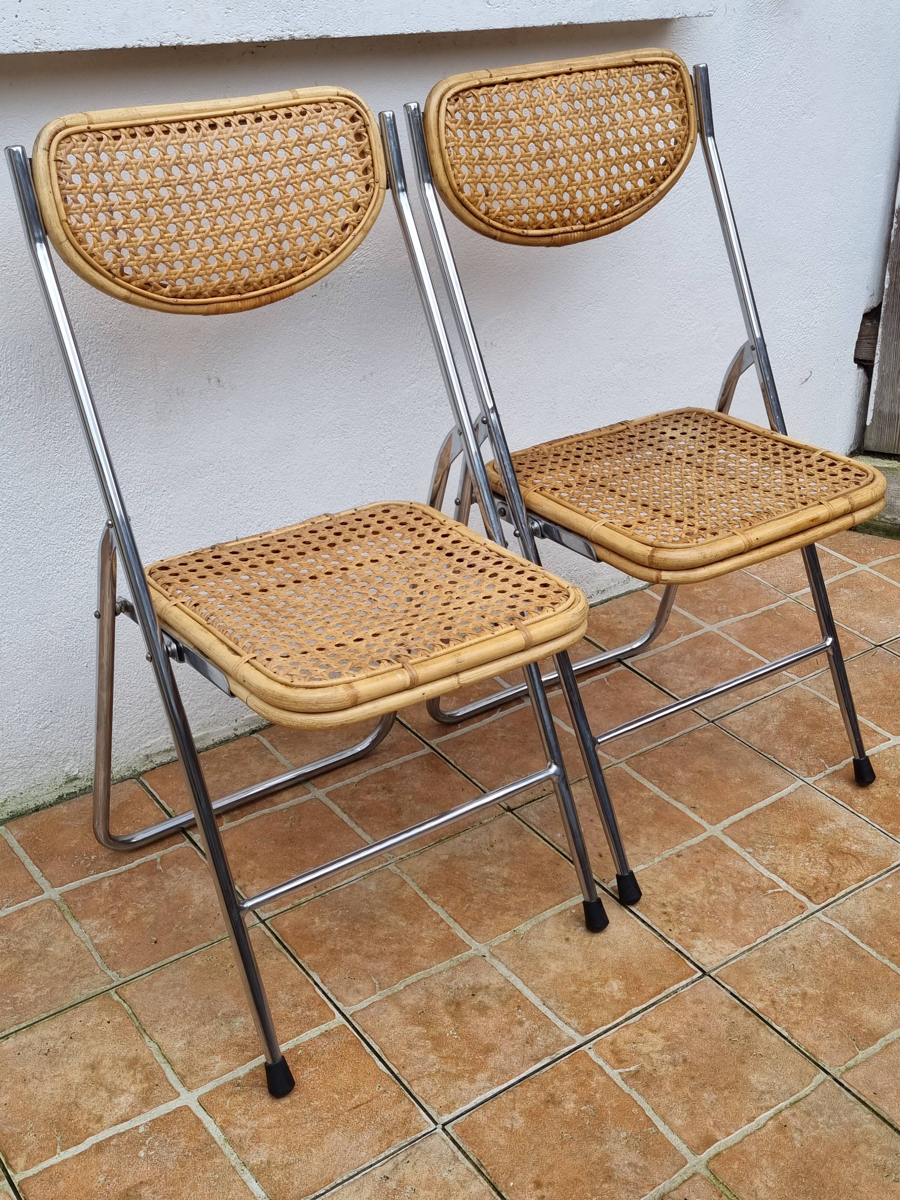 Pair of vintage metal and cane folding chairs