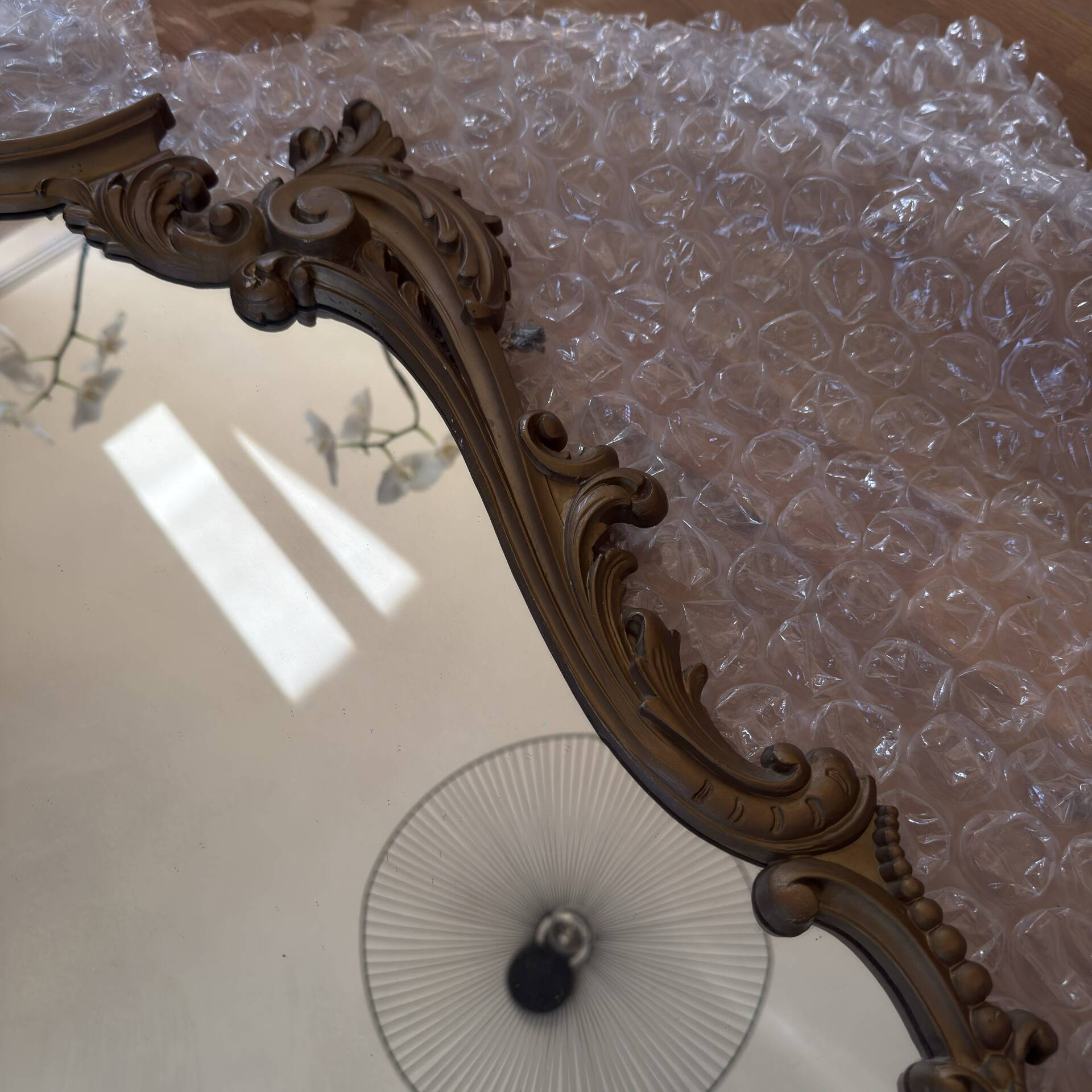 Antique mirror in Louis XV Rocaille style with carved frame.