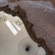 Antique mirror in Louis XV Rocaille style with carved frame.