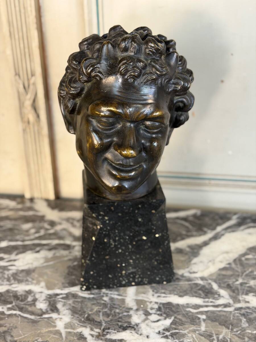 Head of a faun smiling, bronze after the antique, 19th century.