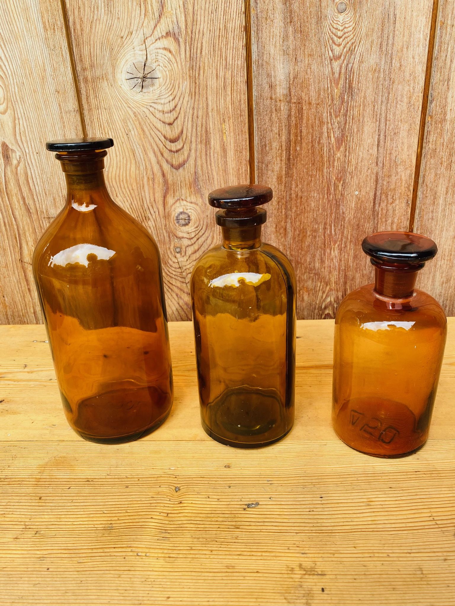 Trio of ancient apothecary bottles of beautiful amber color.