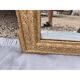 19th-century mirror in gilded wood and stucco.