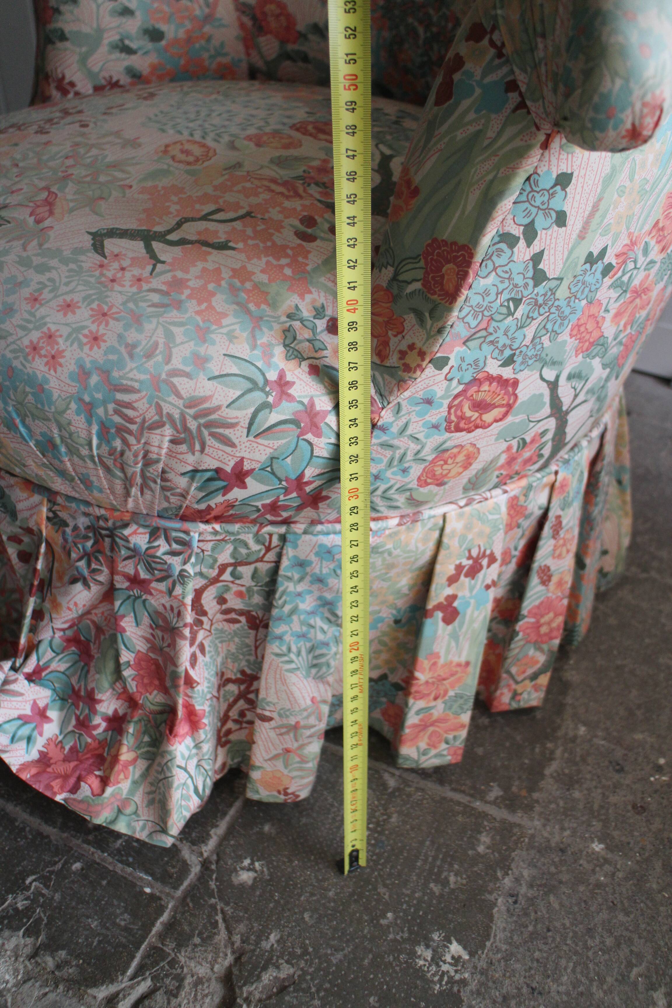 pair of toad armchairs in floral fabric.