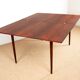 Danish extendable dining table in rosewood and brass by Poul Volther