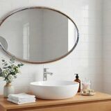 Oval Art Deco mirror with vintage chrome frame from the 1970s.