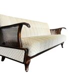 Vintage wooden armchair with rattan weaving.
