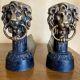 Pair of antique fire dogs with lion heads - patinated cast iron
