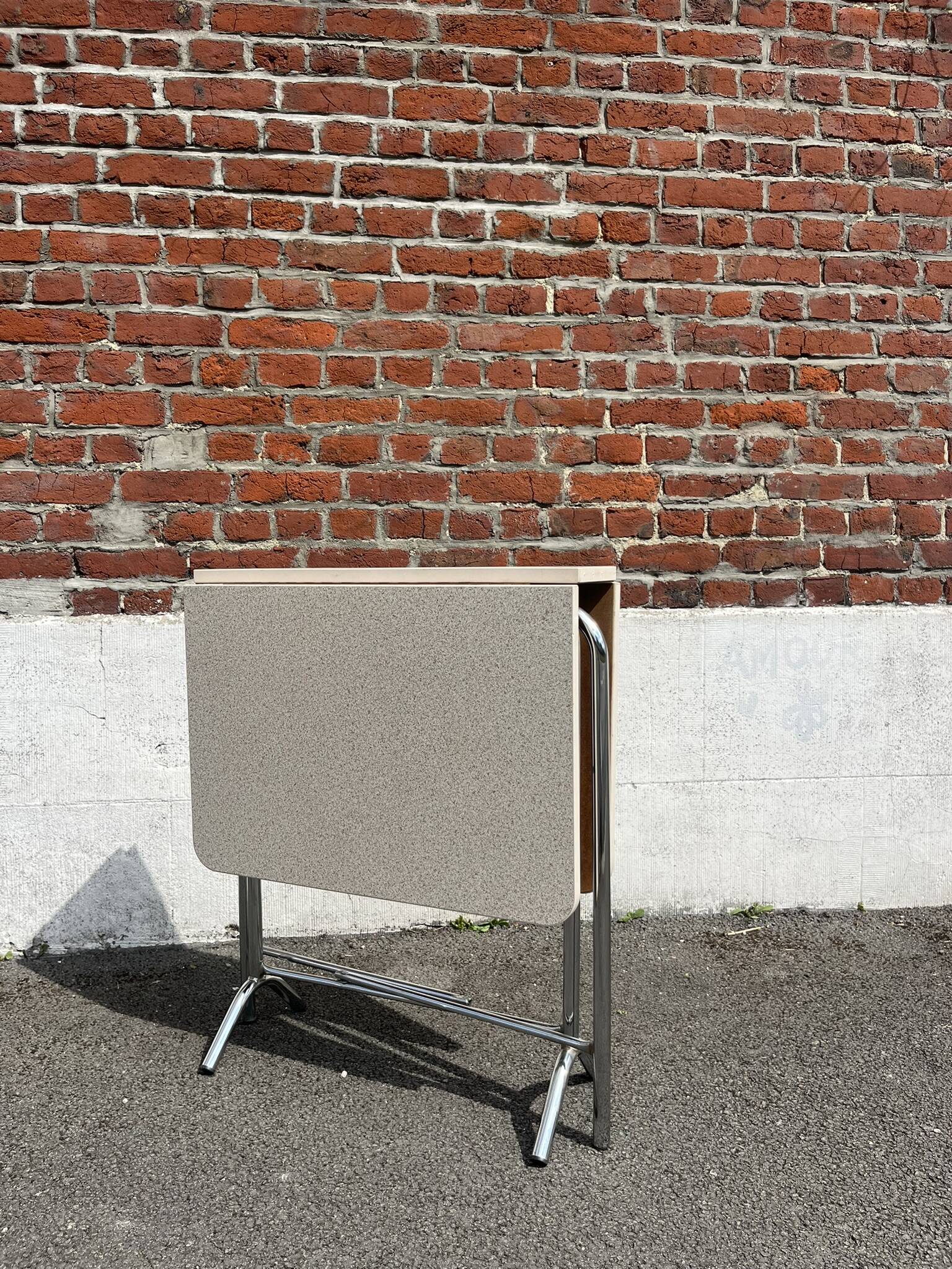 Folding table with chrome and pink formica.