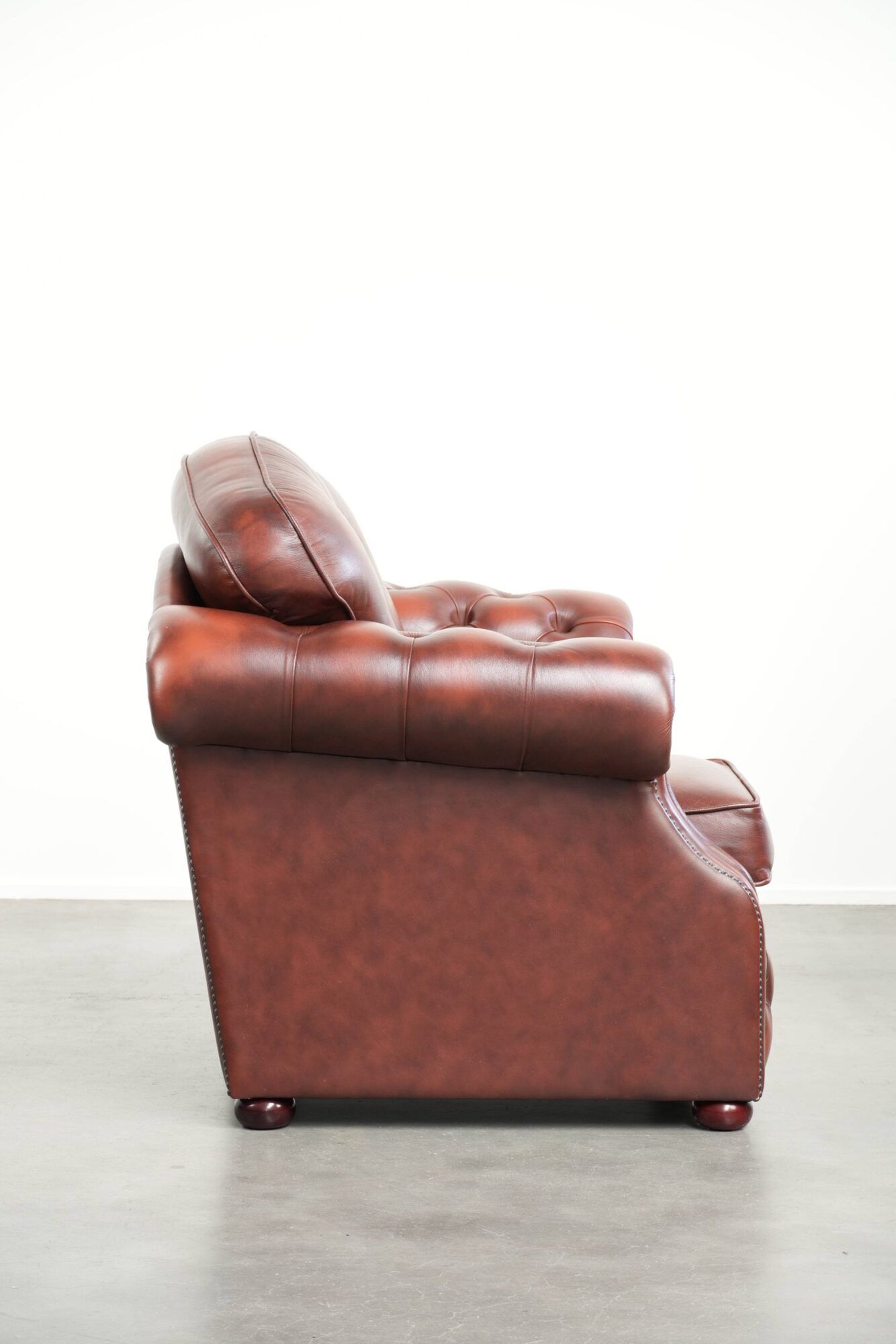 Brown cow leather Chesterfield armchair in a unique design