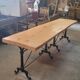 Large bistro table with a wooden top and cast iron legs - 2m56