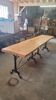 Large bistro table with a wooden top and cast iron legs - 2m56
