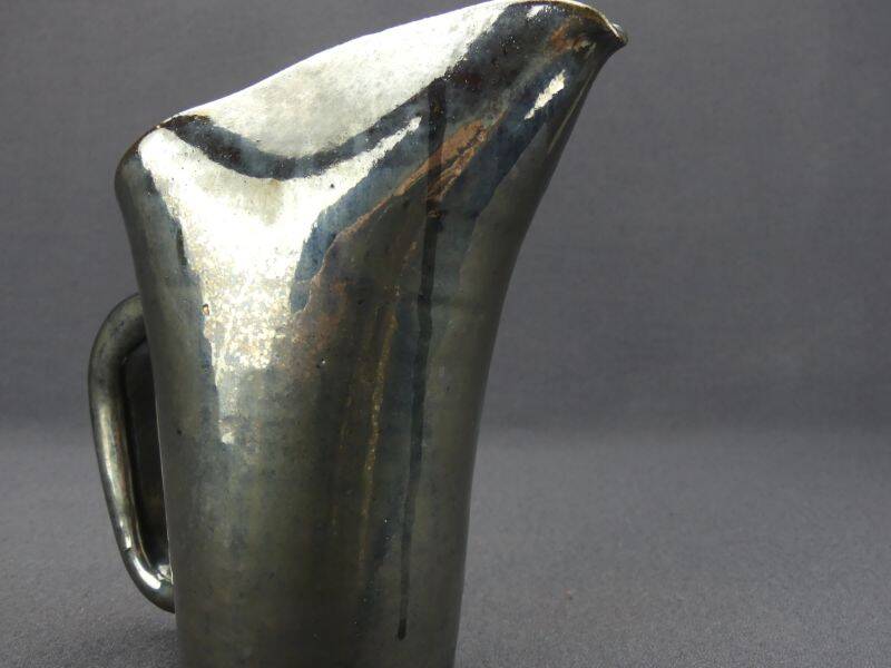 Old Biot, modernist pitcher in iridescent black ceramic.