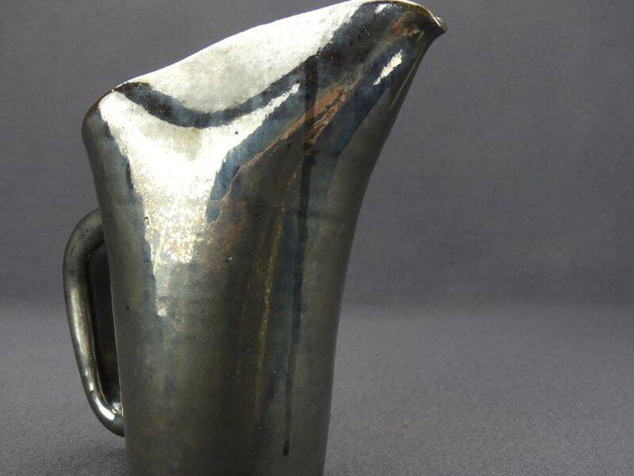 Old Biot, modernist pitcher in iridescent black ceramic.