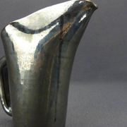Old Biot, modernist pitcher in iridescent black ceramic.