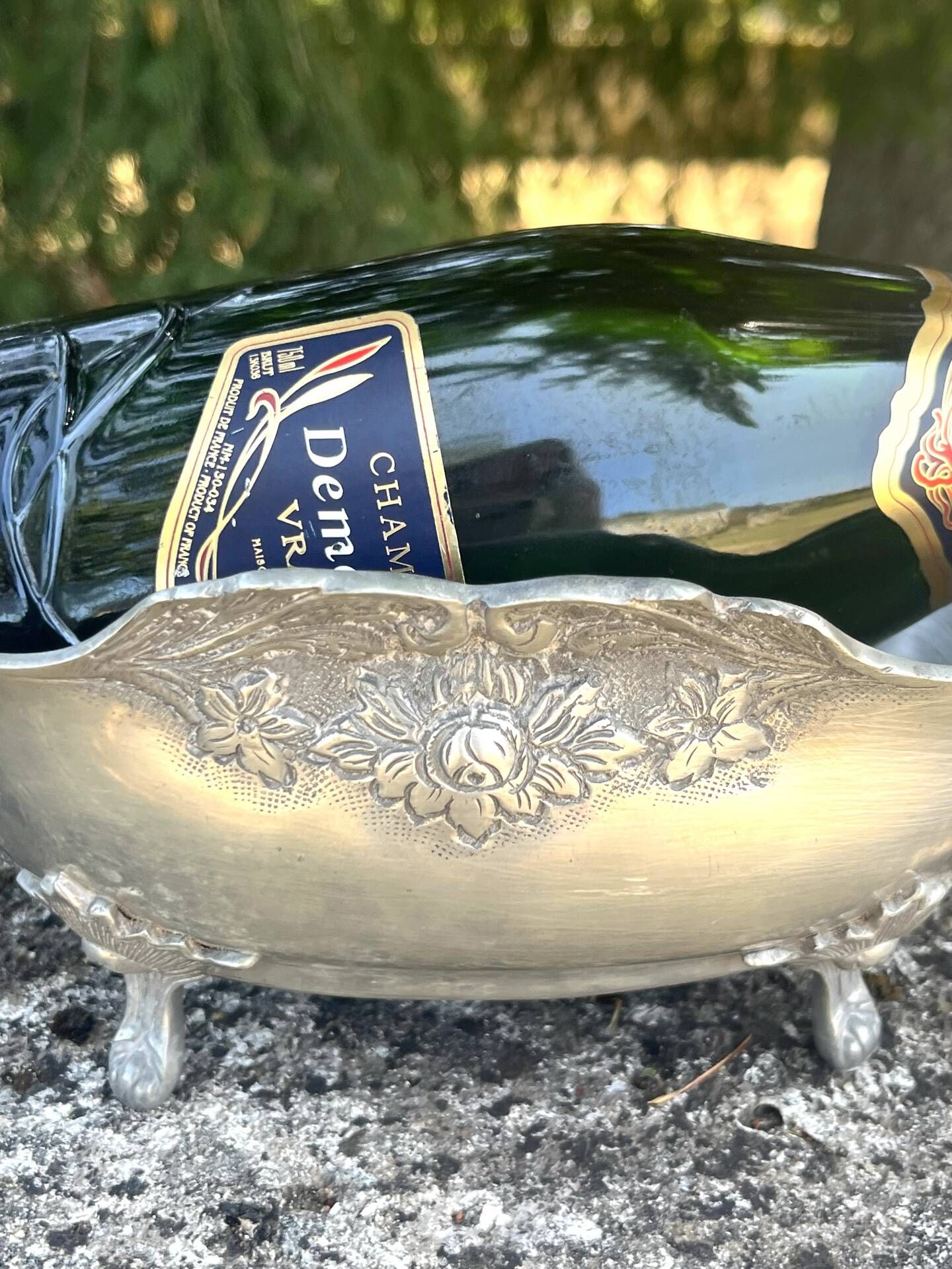 Footed pewter champagne cooler on claw feet with floral relief