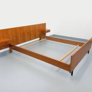 Double bed vintage modernist in teak and black metal from the 1960s with bedside tables.