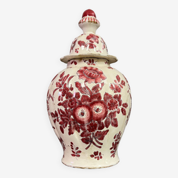 Ceramic covered pot with red decorations on a white background