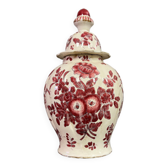 Ceramic covered pot with red decorations on a white background