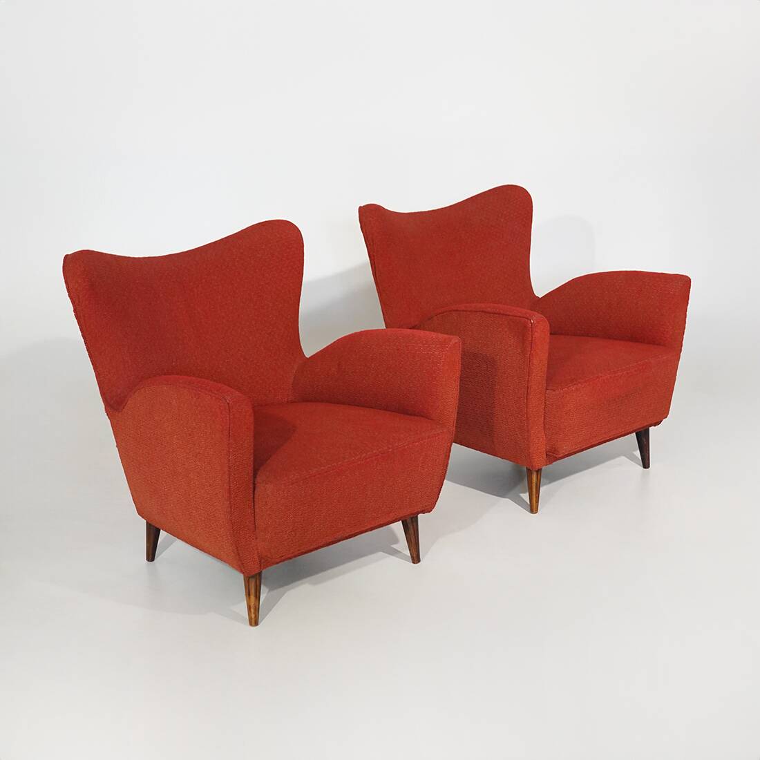 Pair of red armchairs with cone-shaped feet, 1950s