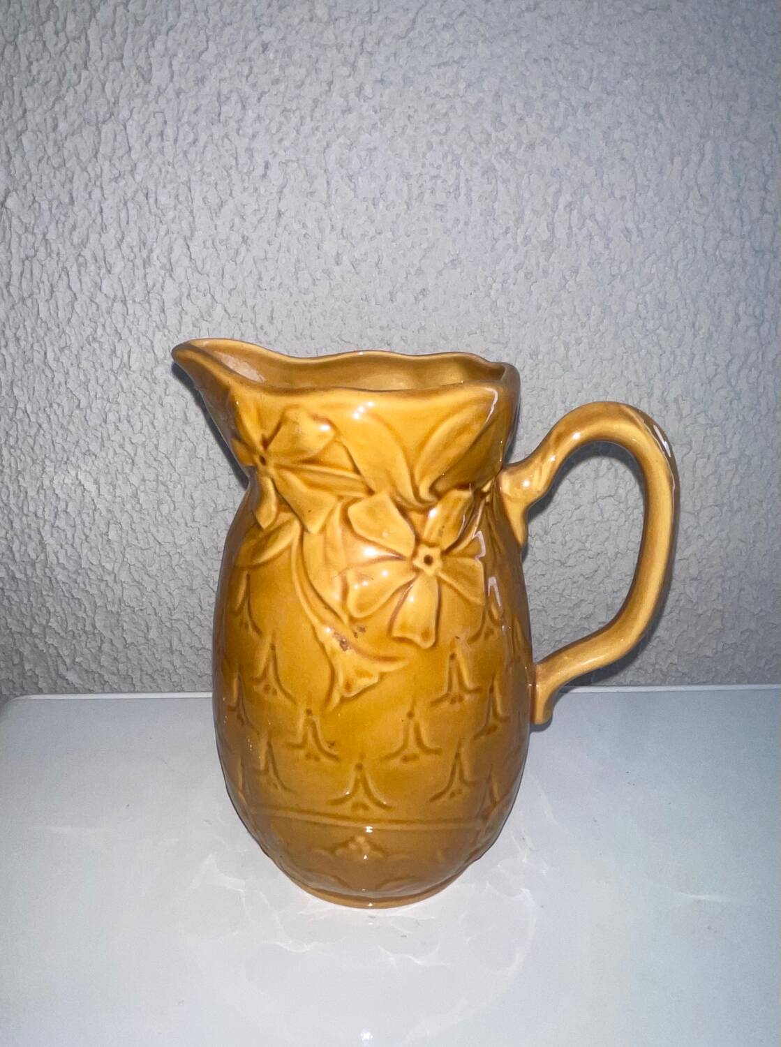 Antique pitcher with flower decoration