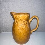 Old pitcher decorated with flowers