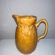 Antique pitcher with flower decoration