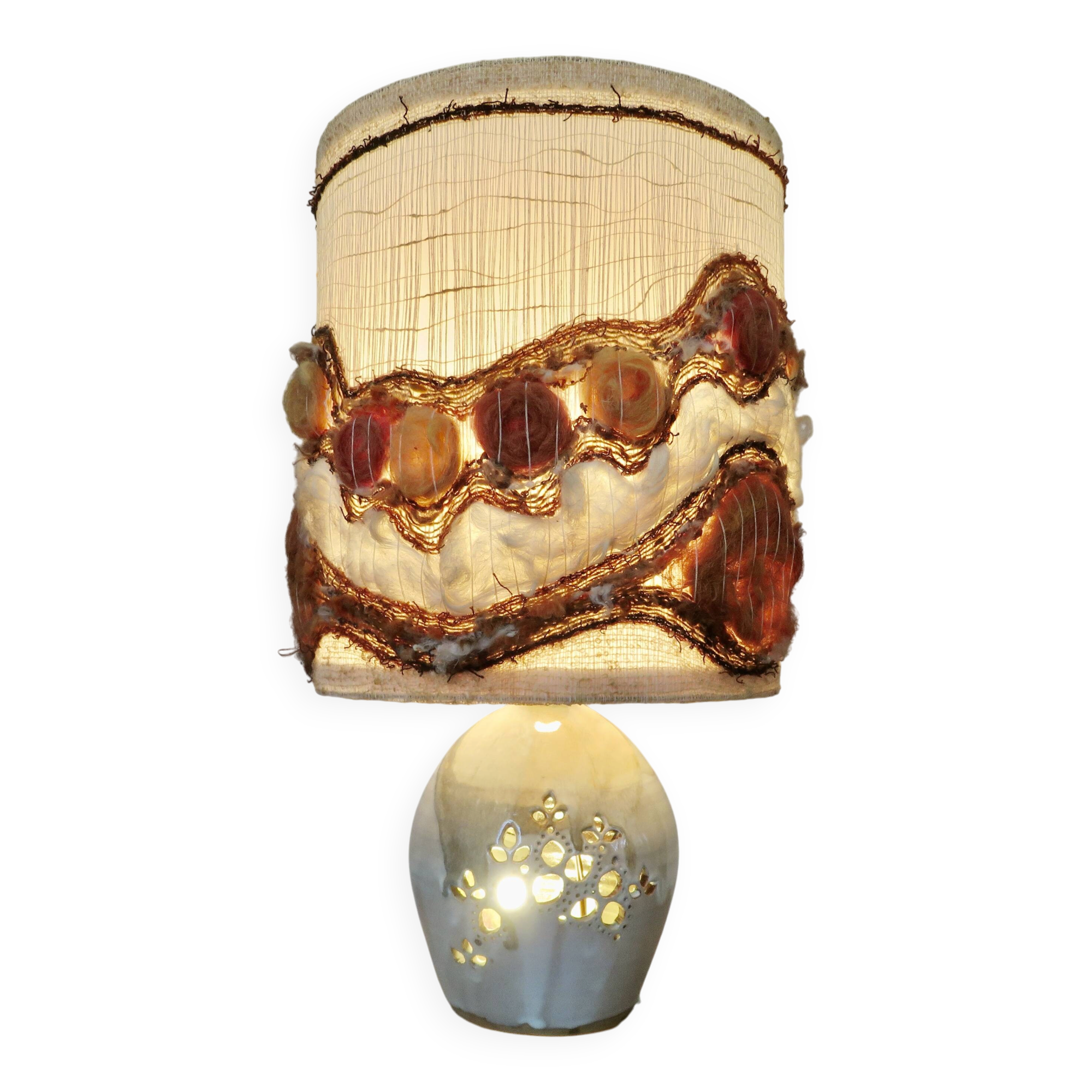 Ceramic lamp with double lighting and openwork design.