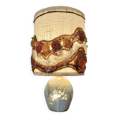 Ceramic lamp with double lighting and openwork design.