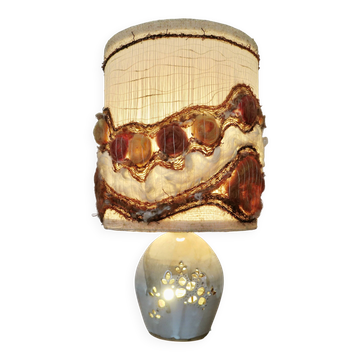 Ceramic lamp with double lighting and openwork design.