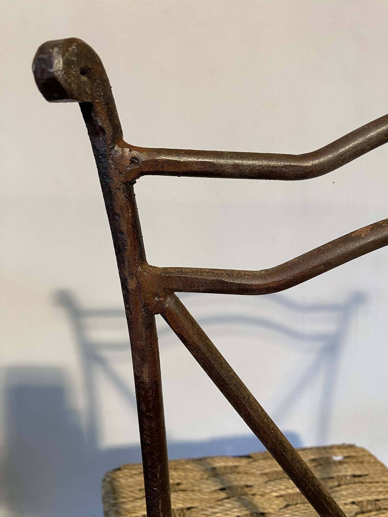Wrought iron chair with woven seat