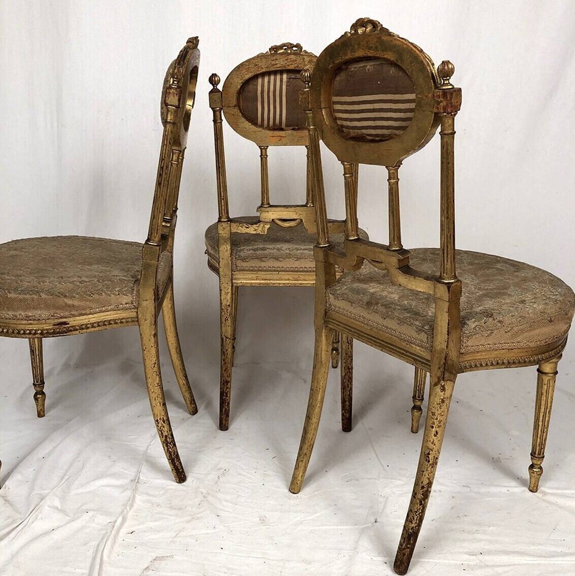 Series of three Louis XVI style chairs in gilded wood, circa 1900
