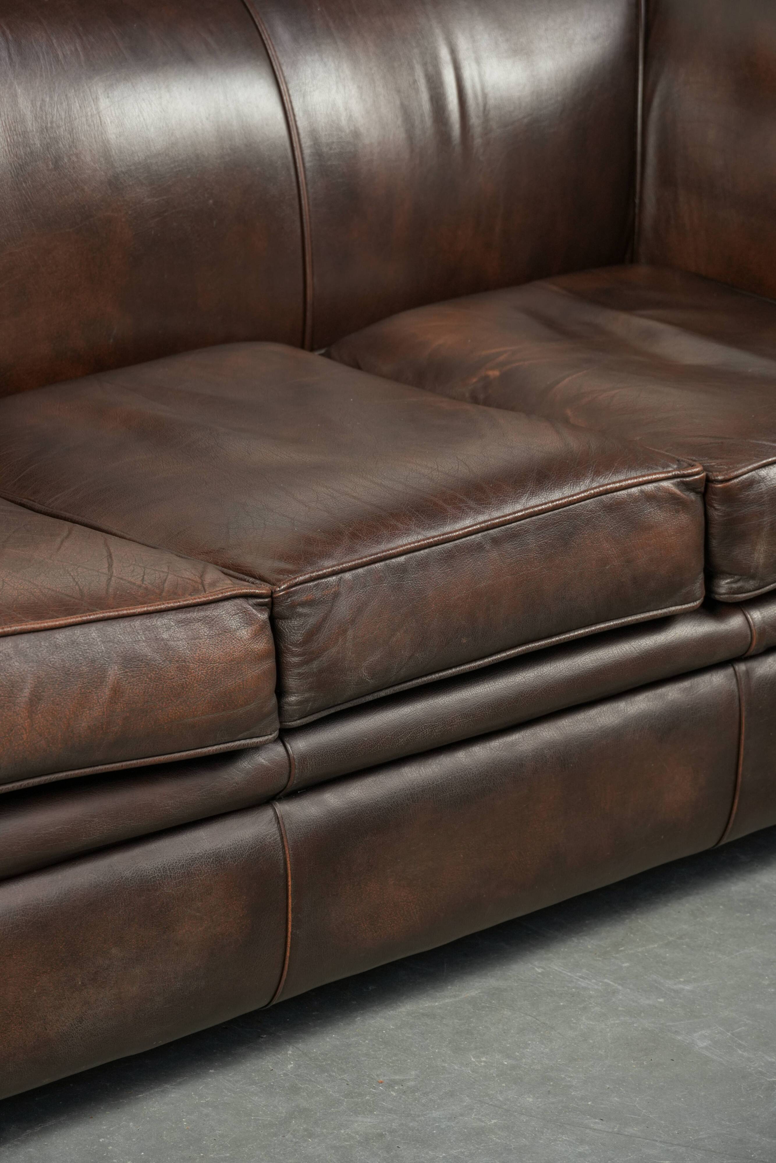 Luxury brown smooth cow leather Chesterfield sofa with an English look
