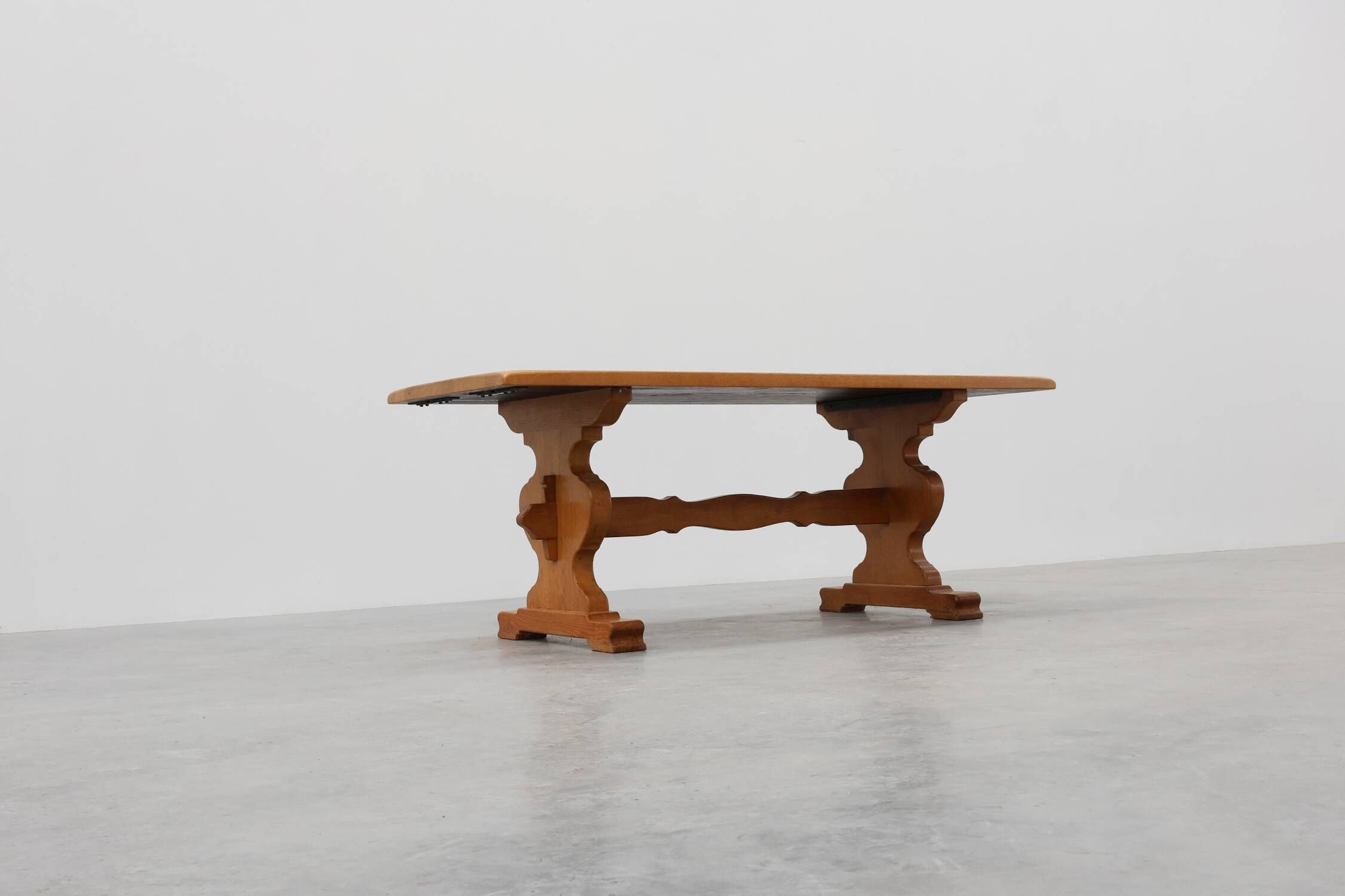 20th Century French oak trestle table with scalloped legs and plank top