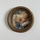 19th century miniature of a young girl with her head resting on a cushion