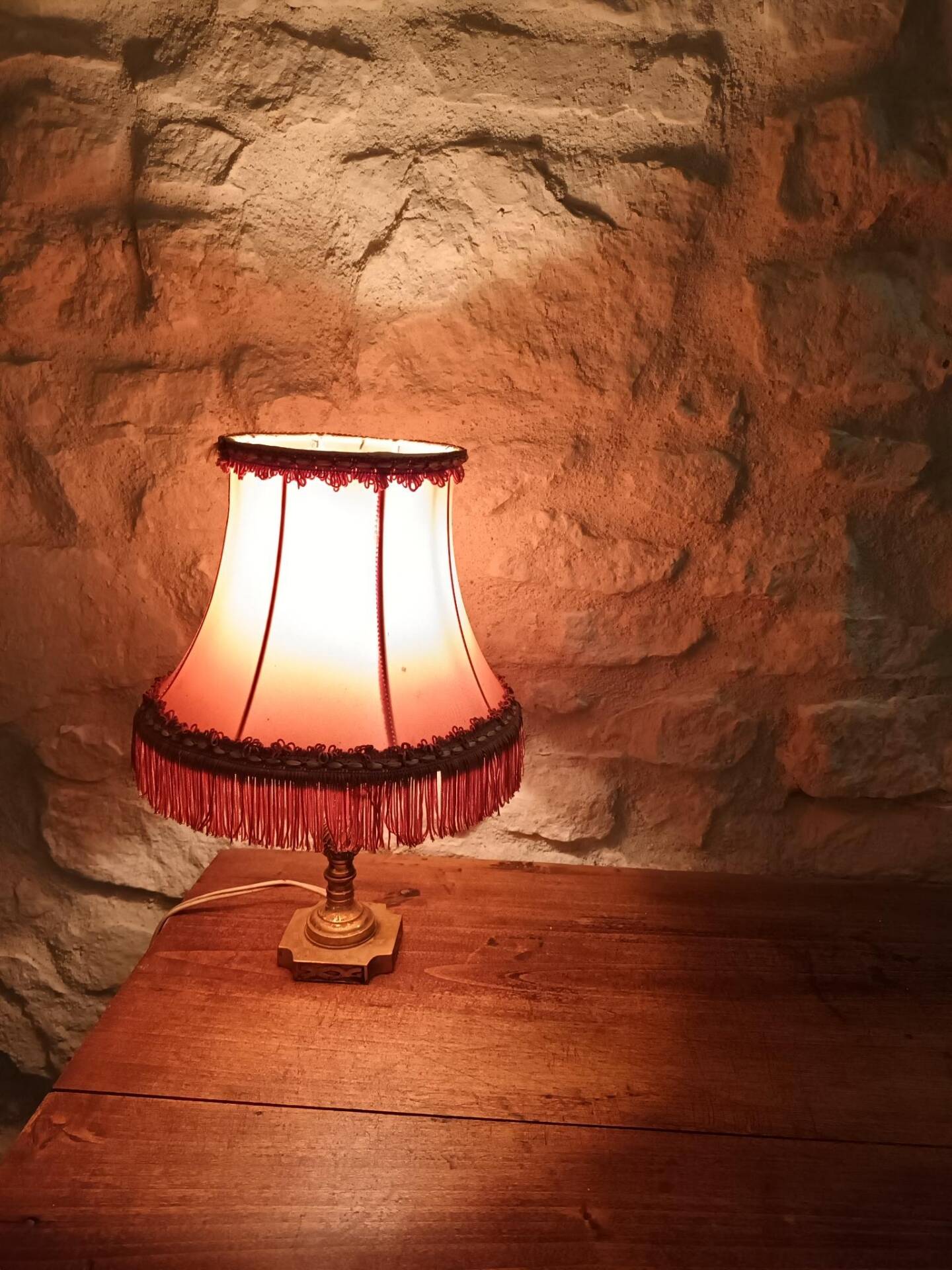 Vintage lamp, pink fringed pagoda shade and brass base.