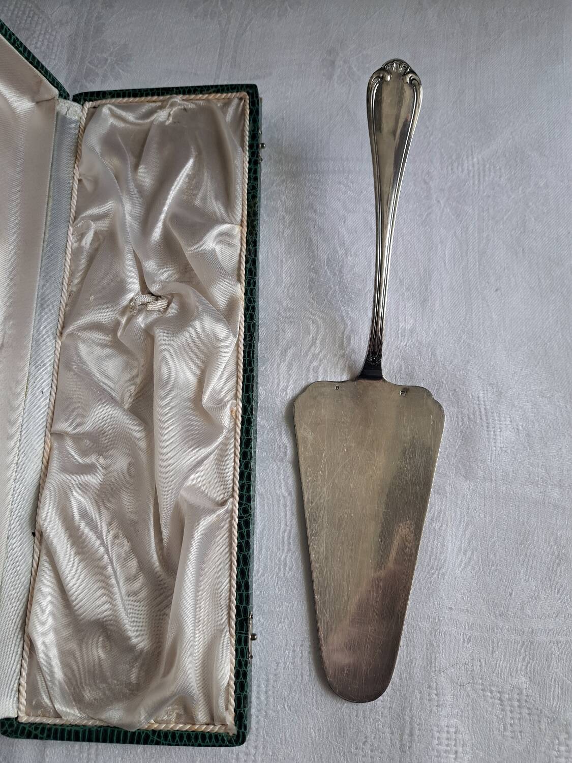 Silver metal cake peeler.