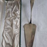 Silver metal cake peeler.